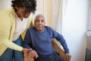 elderly man receiving from social care worker