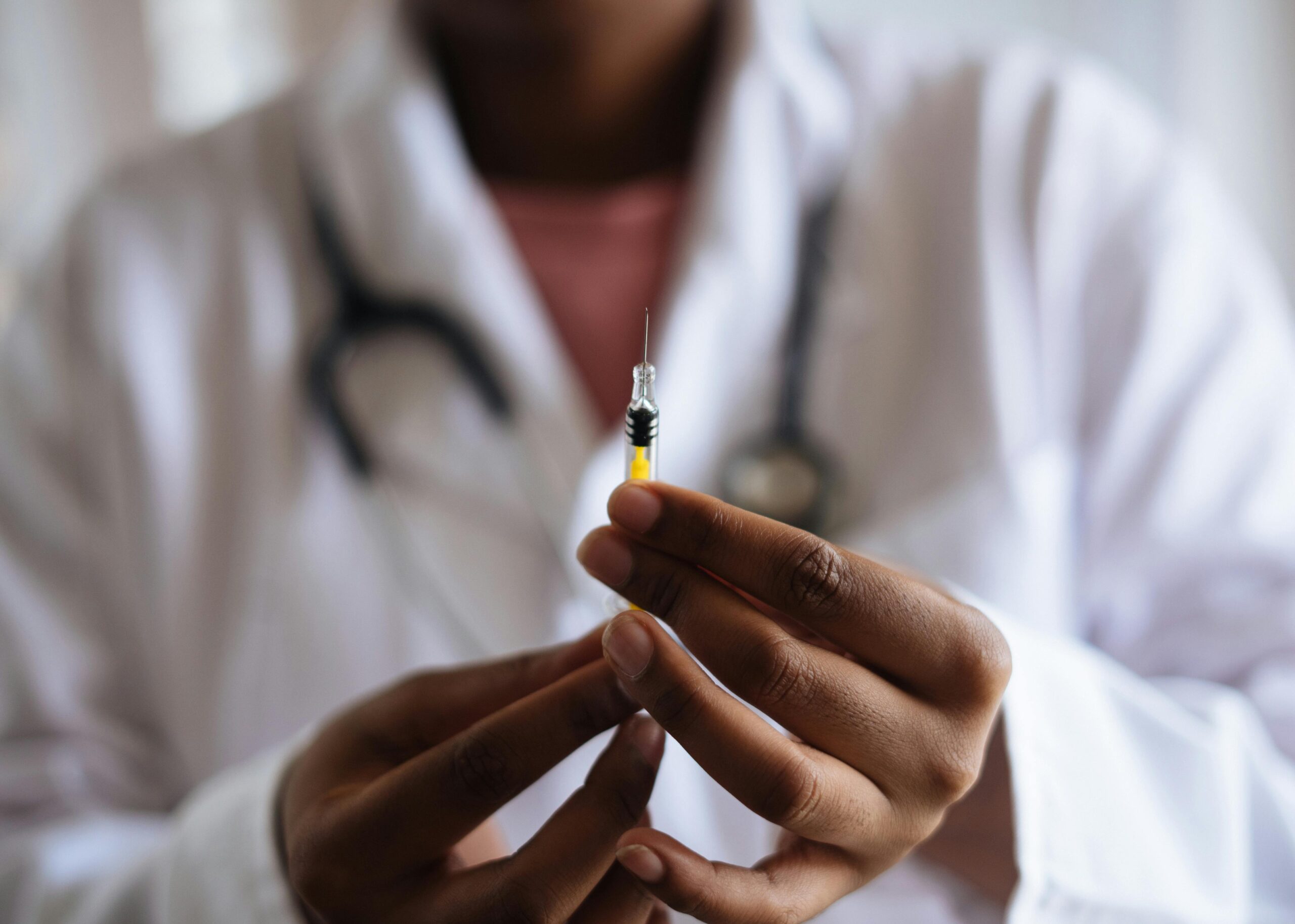 doctor preparing vaccine for dementia patient